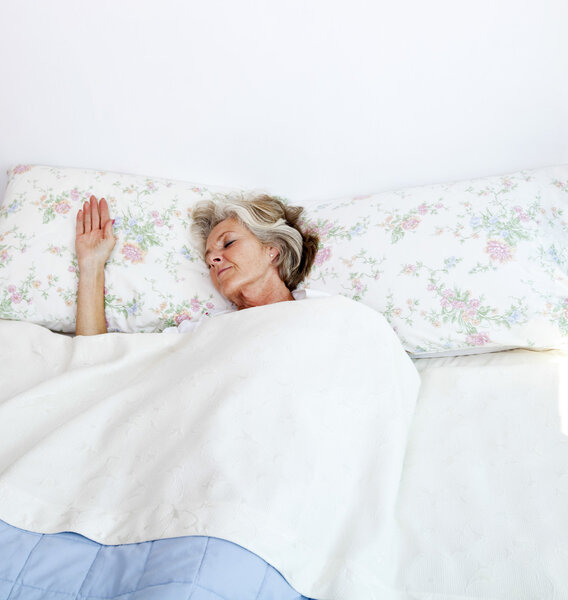 Senior woman sleeping in bed at home