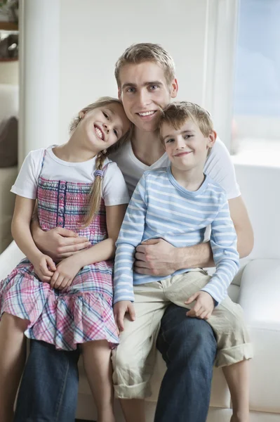 Children sitting on father's laps — Stock Photo, Image
