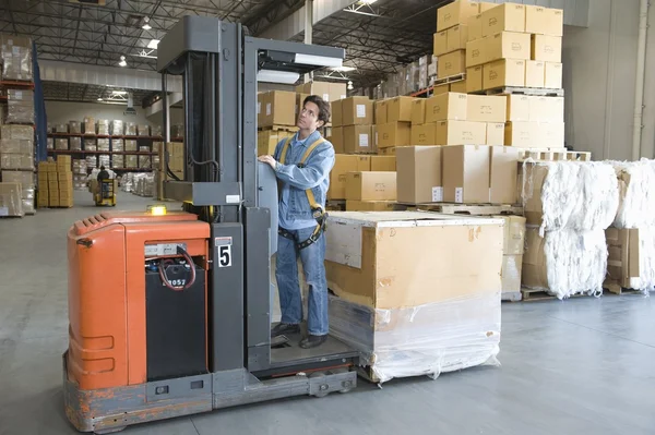 Man operating fork lift truck — Stock Photo, Image