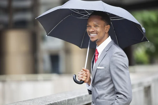 African American businessman with umbrella — Stock Photo, Image