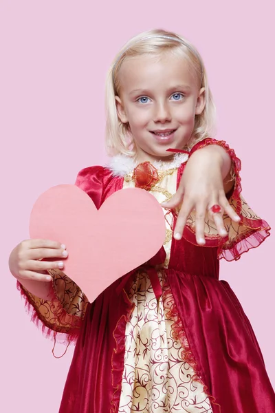 Girl dressed in princess costume holding paper heart — Stock Photo, Image