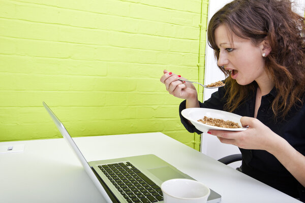 Woman eating at her desk
