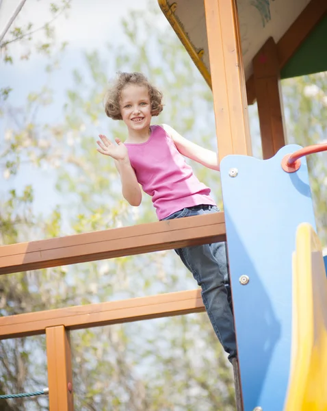 Girl climbing on childrens playground — Stock Photo, Image