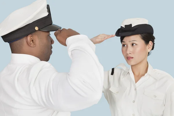 Multi-ethnic Navy officers saluting — Stock Photo, Image