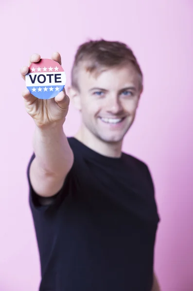 Man holding a VOTE badge — Stock Photo, Image