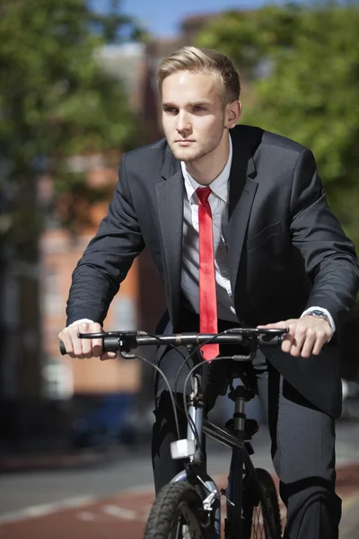 Young businessman riding bicycle — Stock Photo, Image