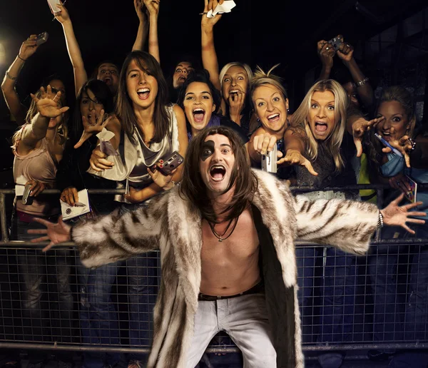 Young man with excited audience — Stock Photo, Image