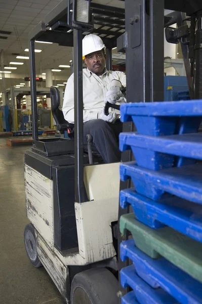 Man driving fork lift truck — Stock Photo, Image