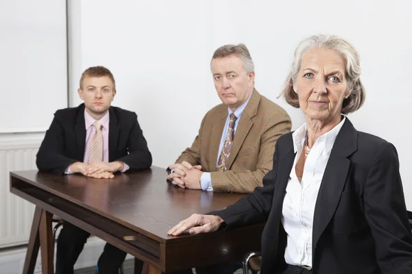 Business group at desk in office — Stock Photo, Image