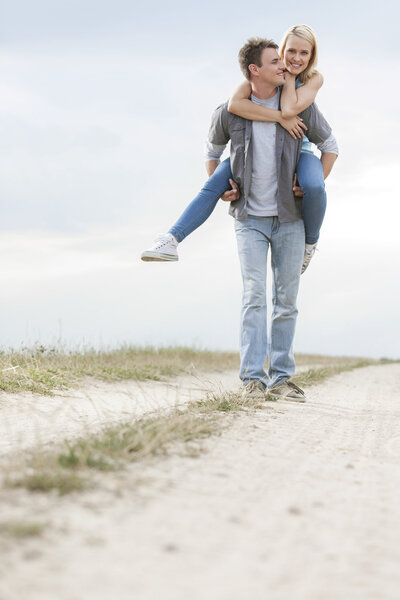 Man giving piggyback ride to woman