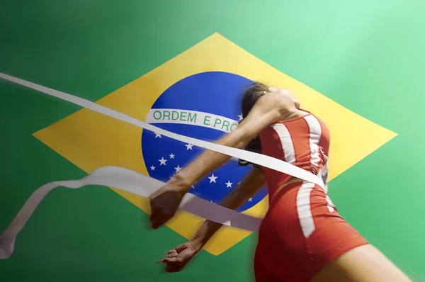 Atleta de pista femenina cruzando la línea de meta — Foto de Stock