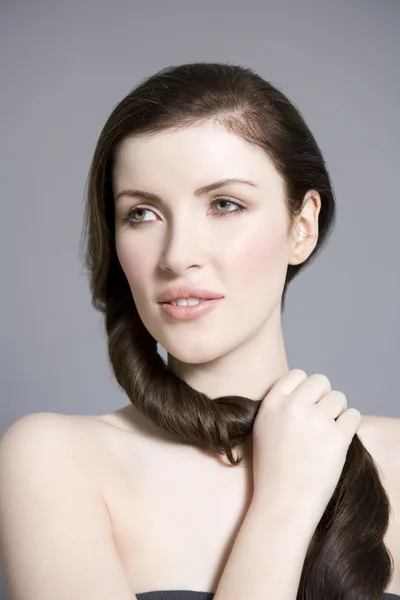 Woman cutting long brown hair — Stock Photo, Image