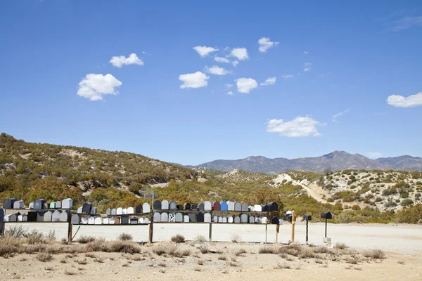 Letter boxes on desert road — Stock Photo, Image