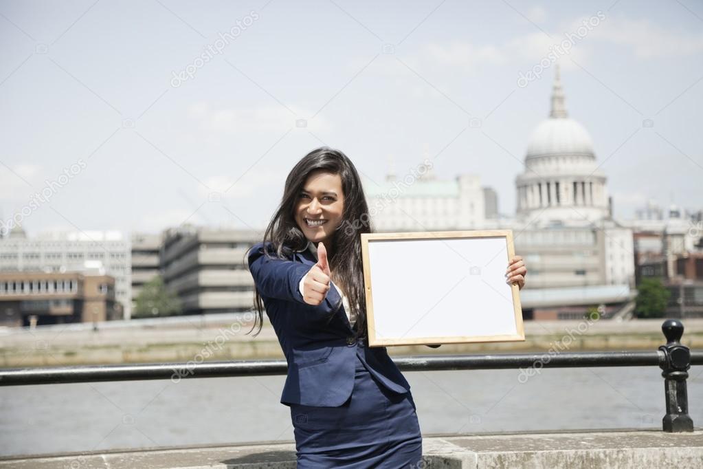Indian businesswoman gesturing thumbs up