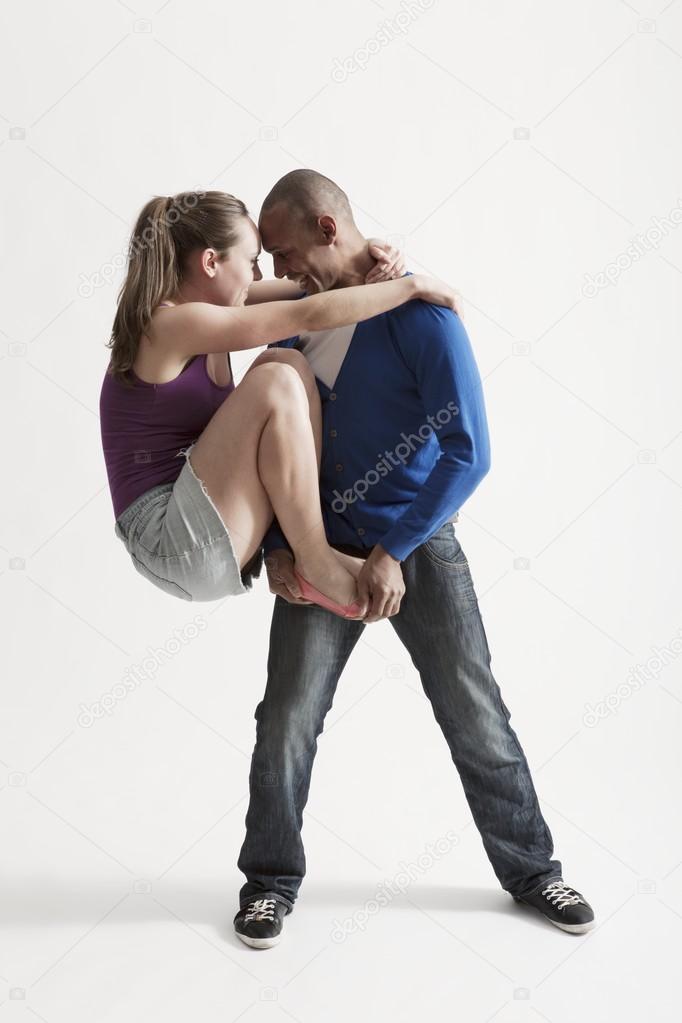 Man supports modern dance partner with barefeet