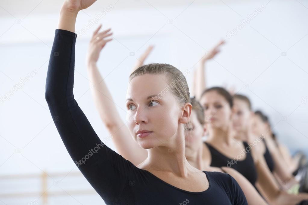 ballet dancers  with arms raised 