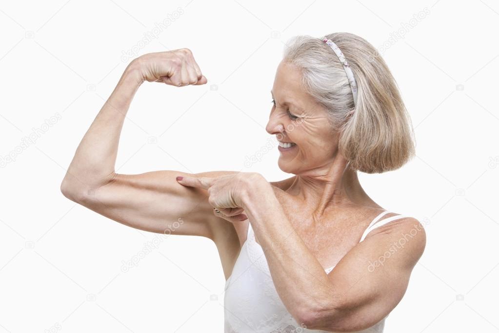 Senior woman flexing muscles
