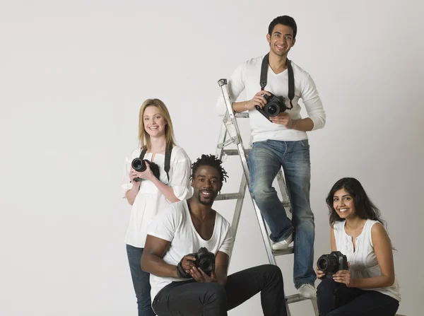 Photographers sitting on ladder and chairs — Stock Photo, Image