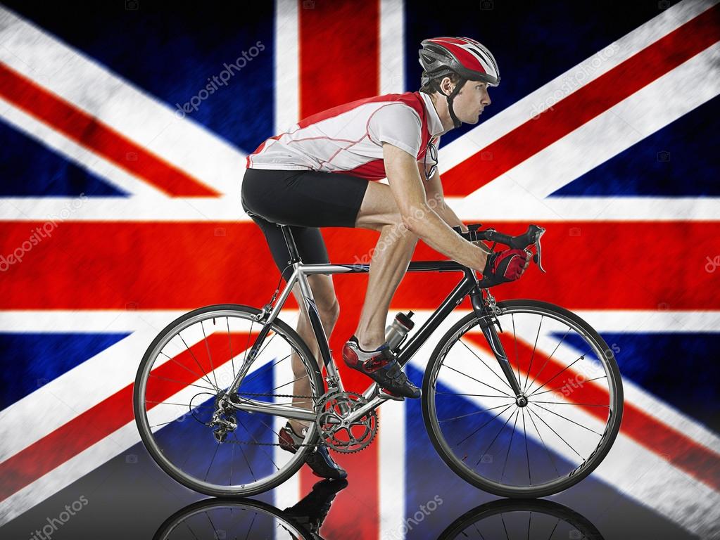 Cyclist cycling in front of Union Jack Flag