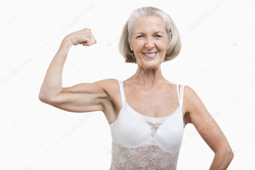 Senior woman flexing muscles Stock Photo by ©londondeposit 34025551