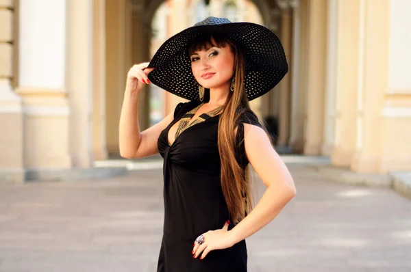 Attractive young lady in a black hat — Stock Photo, Image