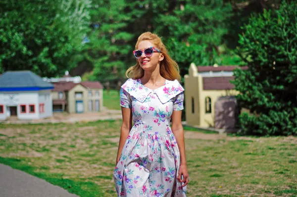 Young lady in vintage dress and sunglasses — Stock Photo, Image
