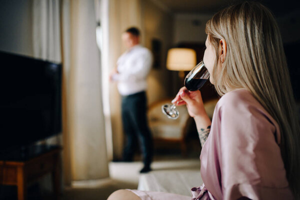 the bride holds a glass of delicious champagne