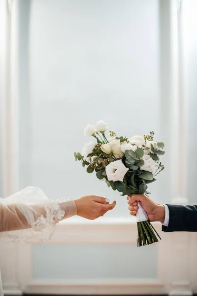 Wedding Bride Reaches Bouquet Held Groom — стоковое фото