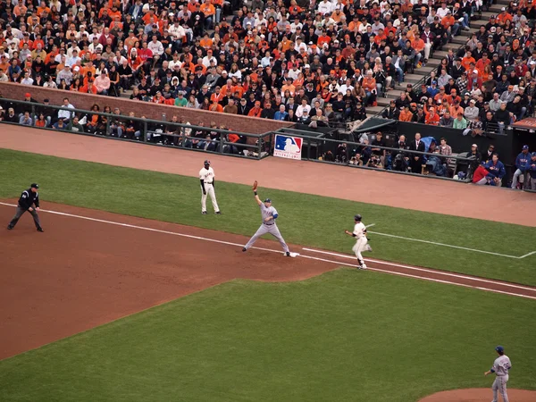 Rangers 1st baseman reaches up for ball as Giants runner sprints — Stock Photo, Image