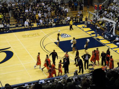 Oregon State Players run towards bench at start of time out clipart