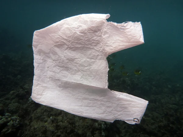 Saco de plástico branco flutua na água do oceano — Fotografia de Stock