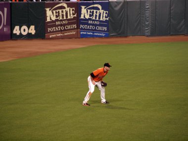 Giants Left Fielder Aubrey Huff stands in a squat in the outfiel clipart
