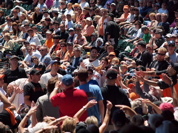 Emocionados fans alcanzan con las manos y guantes para la bola de falta golpeado en th —  Fotos de Stock
