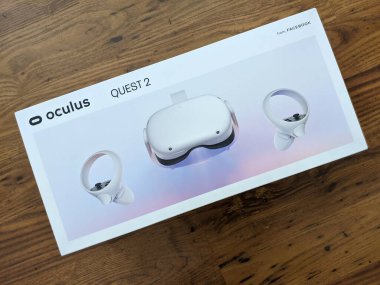 Honolulu - October 17, 2020: Oculus Quest 2 in Box on wood floor.  Oculus Quest 2 is a virtual reality headset created by Oculus, a brand of Facebook. clipart