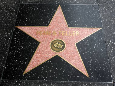 Hollywood, California - October 16, 2019: Penn and Teller star with two mask Logo on Hollywood Walk of Fame. This star is located on Hollywood Blvd. and is one of 2700 celebrity stars.