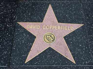 Hollywood, California - October 16, 2019: David Copperfield star with two mask Logo on Hollywood Walk of Fame. This star is located on Hollywood Blvd. and is one of 2700 celebrity stars.