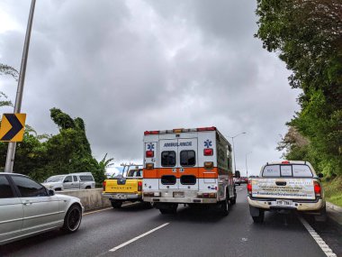 Honolulu - July 8, 2021:  Cars and Trucks Traffic separate to make way for Ambulance Van on Pali Road.