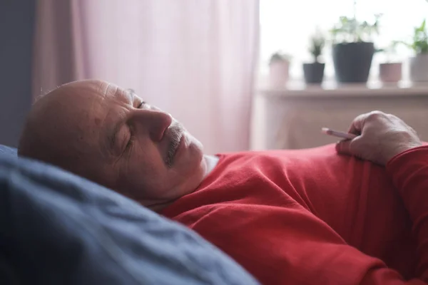 Senior man sleeping having sweet dream on bed in bedroom in the morning — Stock Photo, Image