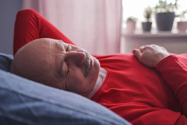 Senior man sover har söt dröm på sängen i sovrummet på morgonen — Stockfoto