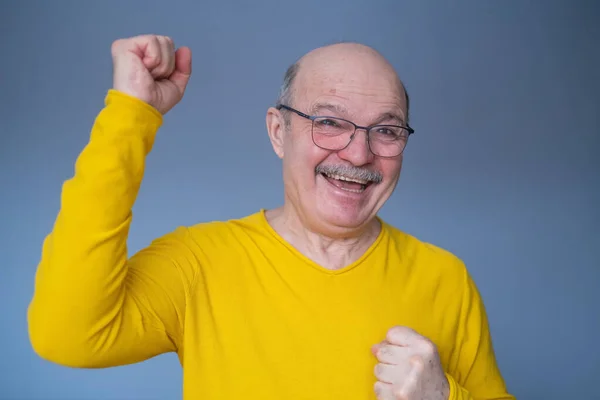 Senior mężczyzna czuje się zszokowany, podekscytowany i szczęśliwy, śmiejąc się i świętując sukces — Zdjęcie stockowe