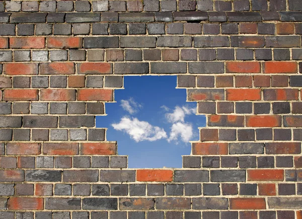 Céu através de um buraco em uma parede de tijolo — Fotografia de Stock