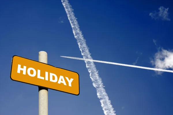 Holiday sign with jet trails in a dark blue sky — Stock Photo, Image