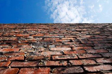 Old brick wall and blue sky clipart