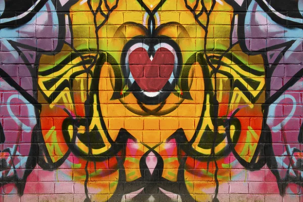 Coração de grafite abstrato em uma parede de tijolo — Fotografia de Stock