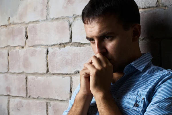 Sad guy against wall — Stock Photo, Image