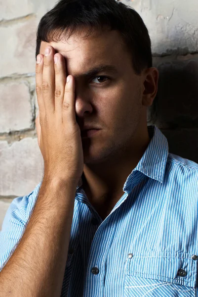 Sad guy against wall — Stock Photo, Image