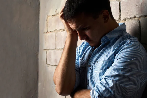 Sad guy against wall — Stock Photo, Image