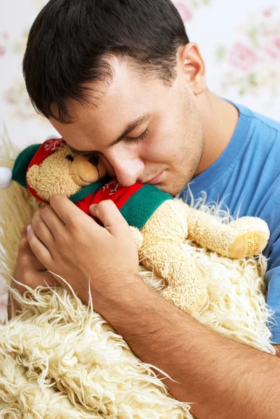 Guy with teddy bear in his hands — Stock Photo, Image