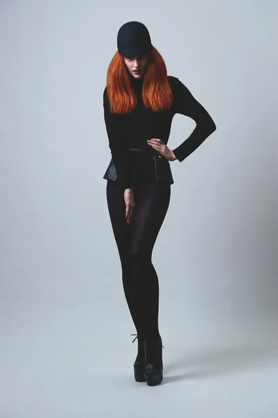 Red haired horsewoman on high heels
