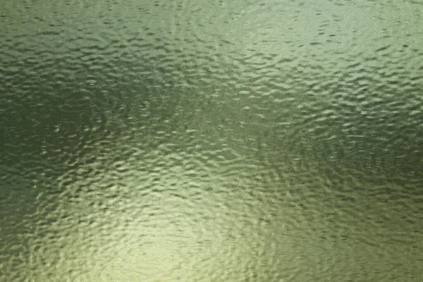 Texture of green frosted glass sheet with scratches, abstract texture background